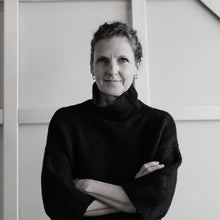 Load image into Gallery viewer, Black and white portrait of Holly Ann Friesen wearing a dark sweater with arms crossed.