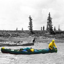 Load image into Gallery viewer, Two canoes on a river, one a historical photo of George Douglas juxtaposed against  a green canoe with a person in a yellow raincoat, surrounded by trees.

